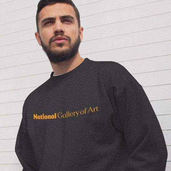 Woman wearing a teal sweatshirt with a graphic of a girl in a dress.