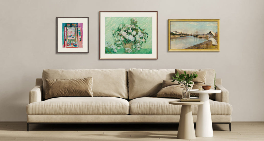 Beige sofa in a living room with framed artwork on the wall.